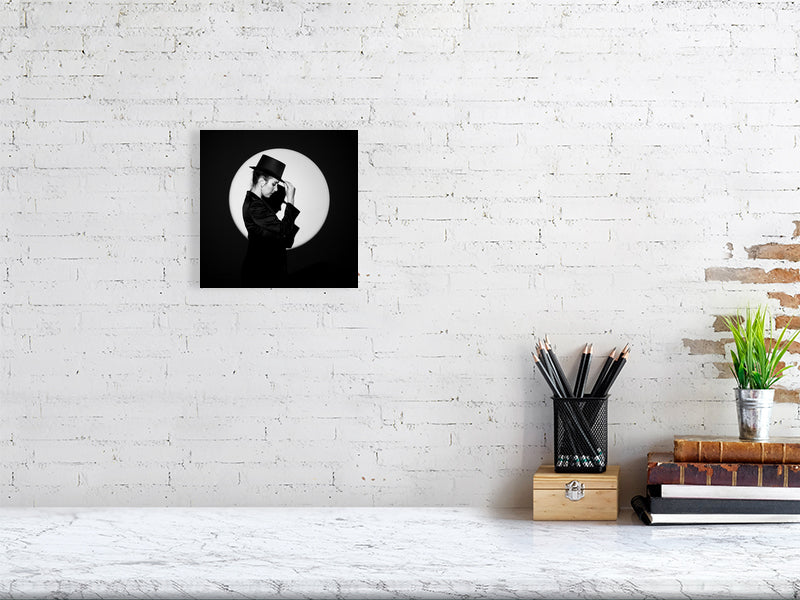 8 x8 print of In the spotlight photograph on a white brick wall.