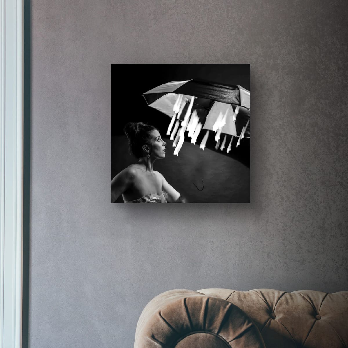 black and white artwork Magical Starlight on a textured wall above a brown sofa.