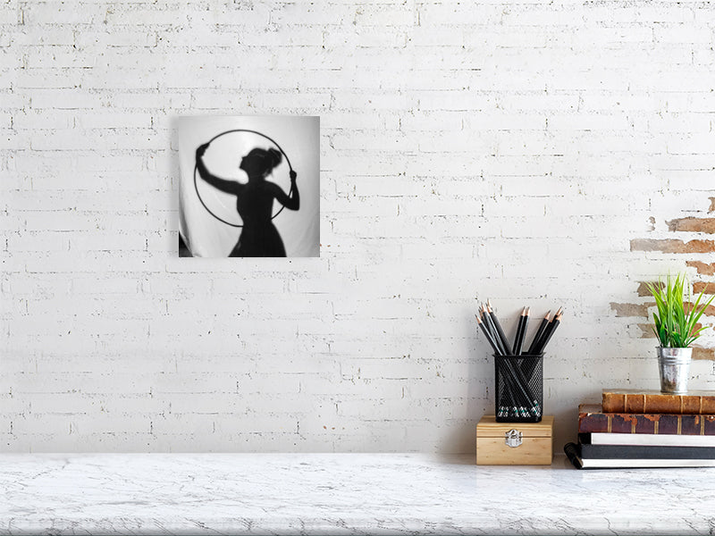 8 x 8 giclee print of a silhouette against a white brick wall with desk items below.